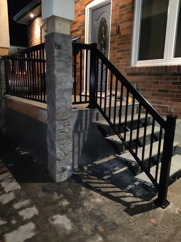 black aluminum railings with stone pillars A-274