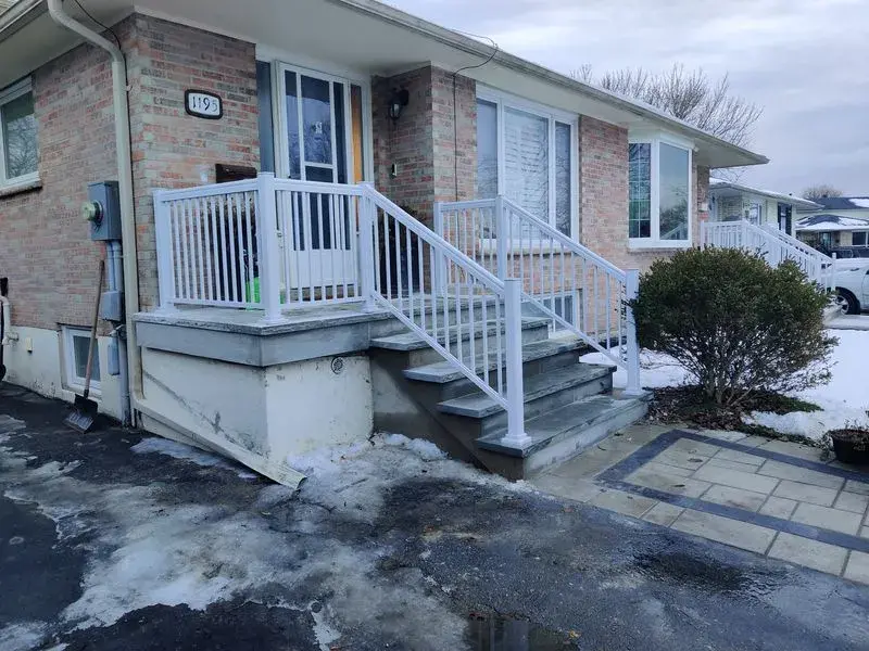 White aluminum porch railings installed on a stone porch (Id A-280)